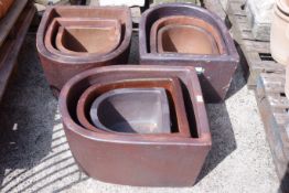 Three sets of three glazed composite graduated stone D shaped planters L62cm, W50cm max,