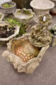 Composite stone water feature depicting a forest scene with otters and squirels,