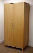 Modern light oak double wardrobe, two doors enclosing hanging rail and single shelf, stile supports,