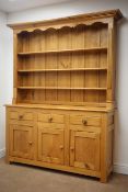 Polished pine dresser, projecting cornice, three shelf back above three drawers and cupboards,