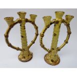 Pair glazed terracotta candlesticks, twisted stem supporting three sconces, H24.