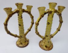 Pair glazed terracotta candlesticks, twisted stem supporting three sconces, H24.
