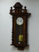Late 19th century walnut Vienna style wall clock, shaped pediment,