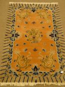 Chinese pink and blue ground wool rug, field of dragons, repeating border,