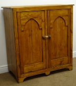 Early 20th century pitch pine cabinet, two panelled doors enclosing fitted interior, shaped apron,