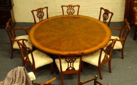Satinwood and burr walnut cross banded mahogany circular dining table on four turned supports and