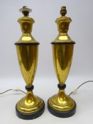 Pair of brass urn shaped table lamps on circular ebonised base,