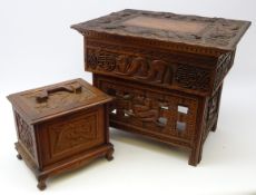 Chinese hardwood table with hinged top and folding supports, heavily carved with Dragons,