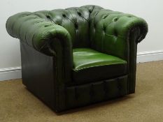 Chesterfield armchair upholstered in deeply buttoned green leather,