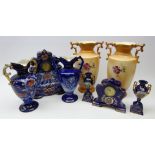 Late Victorian Royal Warwick porcelain clock garniture and a similar clock garniture,