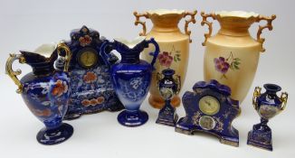 Late Victorian Royal Warwick porcelain clock garniture and a similar clock garniture,