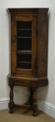 Small early 20th century oak corner cabinet on stand,