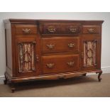 Edwardian walnut sideboard, with five drawers, two glazed cupboard doors, carved and shaped apron