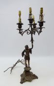 19th century German patinated cast iron figural four branch candelabra, triform moulded base,