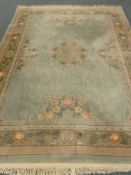 Chinese green ground rug carpet, central floral medallion, repeating border,