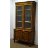Early 20th century oak bookcase with cupboard base,