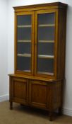 Early 20th century oak bookcase with cupboard base,