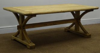 Light wood planked top coffee table, shaped supports joined by single stretcher on sledge feet,
