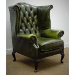 George lll style wingback arm chair, upholstered in a deep buttoned green leather, on cabriole legs,