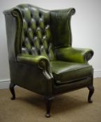 George lll style wingback arm chair, upholstered in a deep buttoned green leather, on cabriole legs,