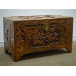 Mid-20th century carved camphor wood blanket chest, depicting an eastern battle scene, hinged lid,