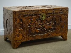 Mid-20th century carved camphor wood blanket chest, depicting an eastern battle scene, hinged lid,
