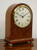 Comitti walnut cased arched top mantel clock, brass bezel and ball feet, No.