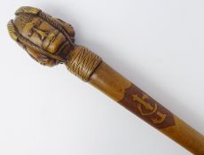 Early 20th century Greek olive wood walking cane, the pommel carved with four male faces,