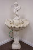 Painted composite stone fountain, small boy holding urn above shell basin on classical style column.