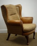 Wing back armchair, scrolling arms, upholstered in check fabric and tan leather,