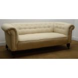 Victorian Chesterfield style sofa upholstered in beige buttoned fabric with turned walnut feet,