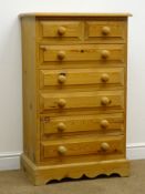 Solid pine chest of two short and five long drawers, turned wooden handles and shaped plinth, W66cm,