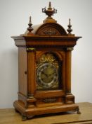 Edwardian oak architectural mantle clock circa 1908, arched top with urn and spire finials,