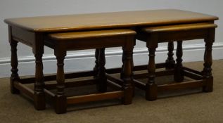 Ercol elm nest of three tables, baluster supports joined by stretchers, W114cm, H40cm,