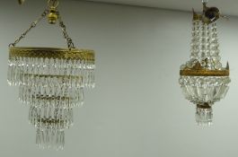 Two gilt metal centre light fittings with cut glass drops,