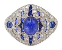 Platinum (tested) ring set with a central cabochon sapphire,