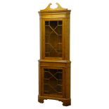 Graduated pair of 20th century golden oak standing corner cabinets,