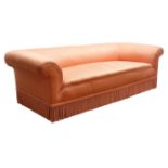 Victorian Chesterfield three seat sofa upholstered in fringed salmon fabric,