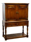 Bevan Funnell Reprodux oak court cupboard, two fielded panelled doors enclosing a fitted interior,