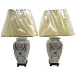 Pair Oriental style blue and white table lamps on ebonised base with shades,