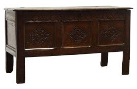 Early 18th century oak coffer, moulded hinged lid above leaf carved frieze and three panel front,