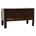 Early 18th century oak coffer, moulded hinged lid above leaf carved frieze and three panel front,