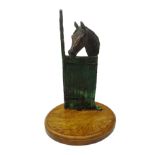 Patinated bronze study of a Horse in stable mounted on oval oak plinth,
