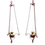 Pair painted cast iron hanging oil lanterns, openwork frame, chain fitting with brass oil lamps,