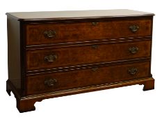 Reproduction bespoke walnut chest of three long drawers, with chased brass handles,