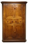 Large 18th century oak corner cabinet, with four fielded panelled doors, three centre drawers,