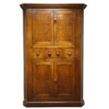 Large 18th century oak corner cabinet, with four fielded panelled doors, three centre drawers,