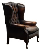 George lll style wingback armchair, upholstered in deep buttoned brown leather, on cabriole legs,