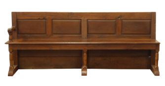 Large 19th century oak church pew, four panel back, plank seat with end arm rest,