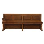 Large 19th century oak church pew, four panel back, plank seat with end arm rest,